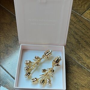Nicola Bathie golden tulip and pearl earrings.